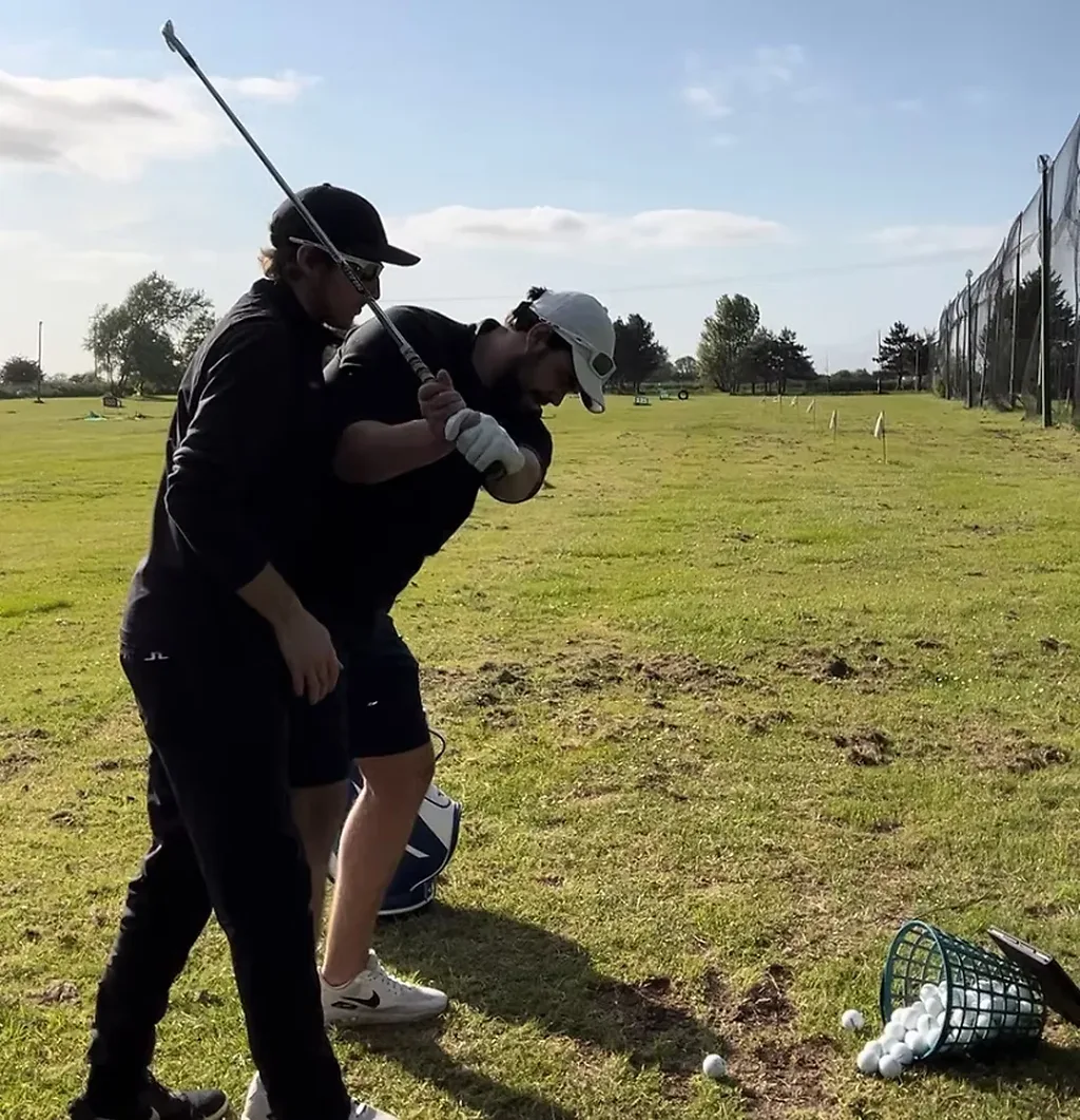 Joe Allenby coaching a golfer
